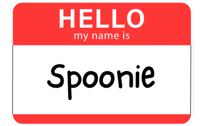 The image shows a typical red and white "Hello, my name is" type of name-tag. In the white space where the name goes, the word "Spoonie" is written in black letters. 